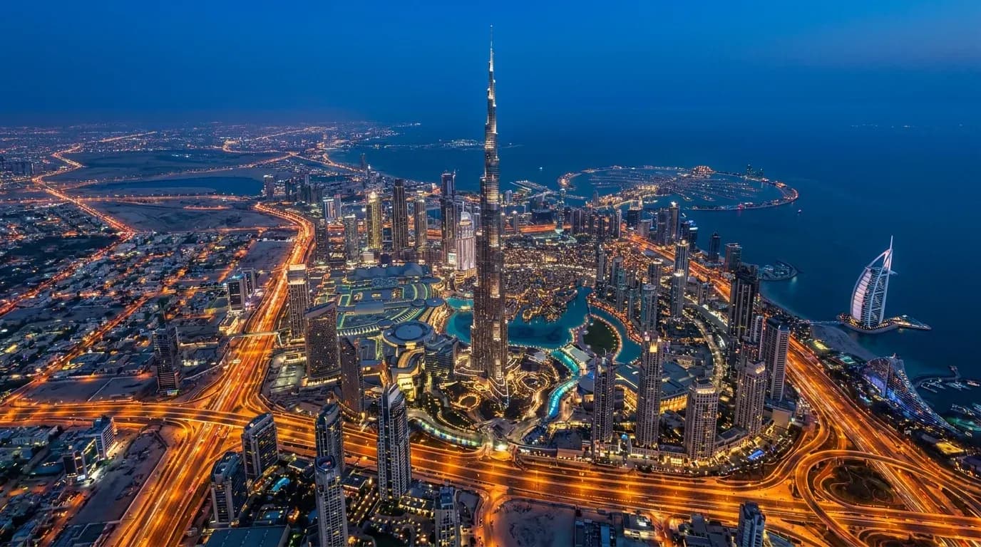 Aerial view of Dubai at blue hour with the illuminated skyline